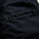 Close-up of linen fabric and stitching on black cycling shorts with pockets, highlighting texture and quality.