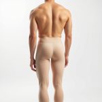 A model wearing high waist tights yoga pants mens in beige, back view, studio shot on white background.