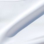 Close-up of recycled fabric texture and stitching on long sleeve yoga tops compression crop top, highlighting material quality.