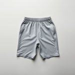 Heather Grey yoga pants mens and yoga shorts for guys neatly folded in a minimalist flat lay.