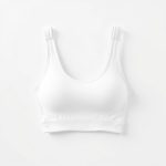 White yoga singlet and sports bra on a white background, hyperrealistic studio photo.