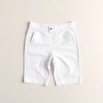 Flat lay of black bike shorts with pockets, no front seam, folded neatly on a clean white surface.