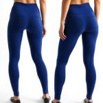 Back view of a model wearing black leggings with pockets in Royal Blue, showcasing seamless fit on white background.