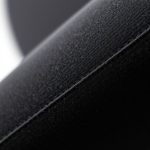 Close-up of the colourful yoga pants womens black flares fabric texture and stitching.