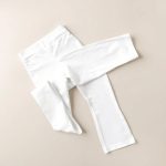 White cotton yoga pants Australia flare legging folded on a neutral surface.