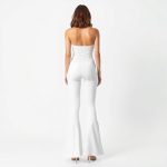 Back view of a model in white cotton yoga pants australia flare legging on a white background.