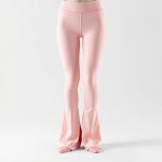 Pastel pink flared leggings women with invisible scrunch detail, hyperrealistic studio shot on white background.