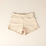 High waisted yoga shorts in beige, Australian activewear, flat lay on a clean surface.
