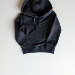 Flat lay of the charcoal lulu flare yoga hoodie folded on a clean surface.