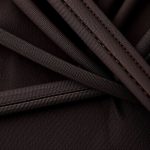 Close-up detail of the wrap crop top ceremony cacao fabric texture and stitching.