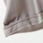Close-up of the soft, breathable organic cotton fabric in this yoga crop top, highlighting its quality stitching.