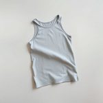Flat lay of a Heather Grey yoga tank yoga mat grip towel folded neatly on a neutral surface.