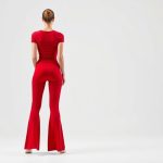 Back view of a red yoga tshirt active wear flares, showcasing the fit on a model against a white background.